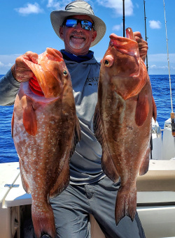 Kevin Adney holding red grouper caught Bottom Fishing