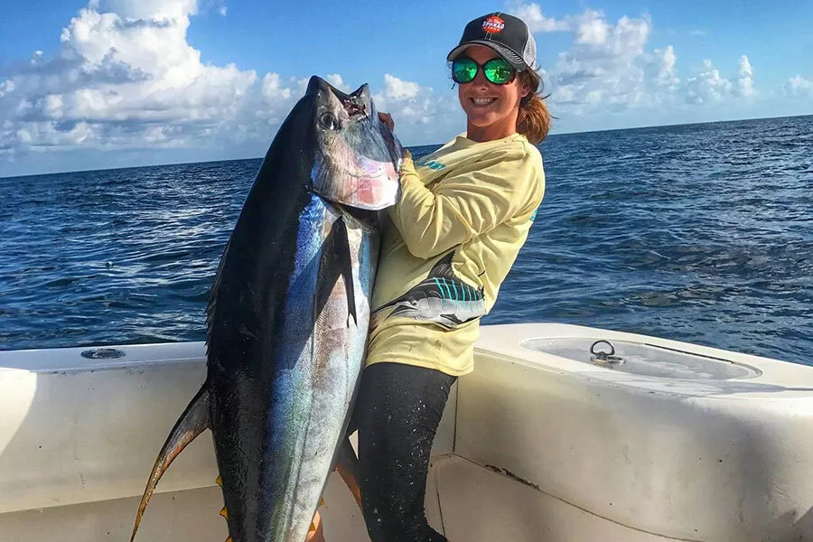 female angler lands big yellowfin tuna off of Venice, Louisian using light tackle Shimano Talica 25