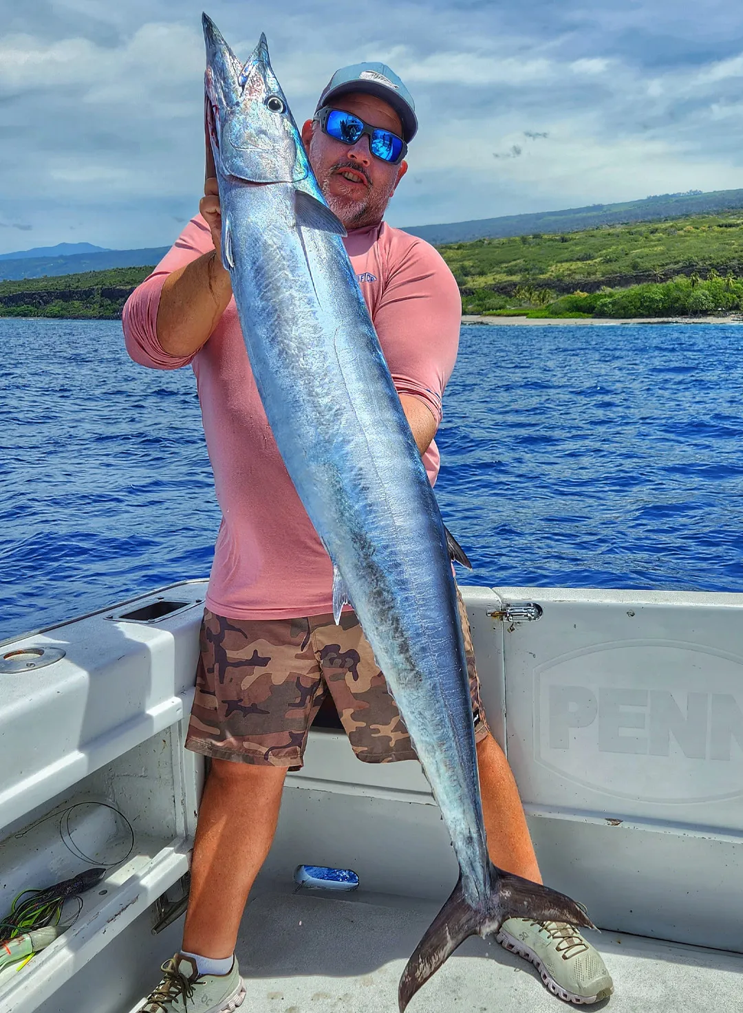Shawn Rotella holding a Wahoo caught on live bait around Hawaiian structure