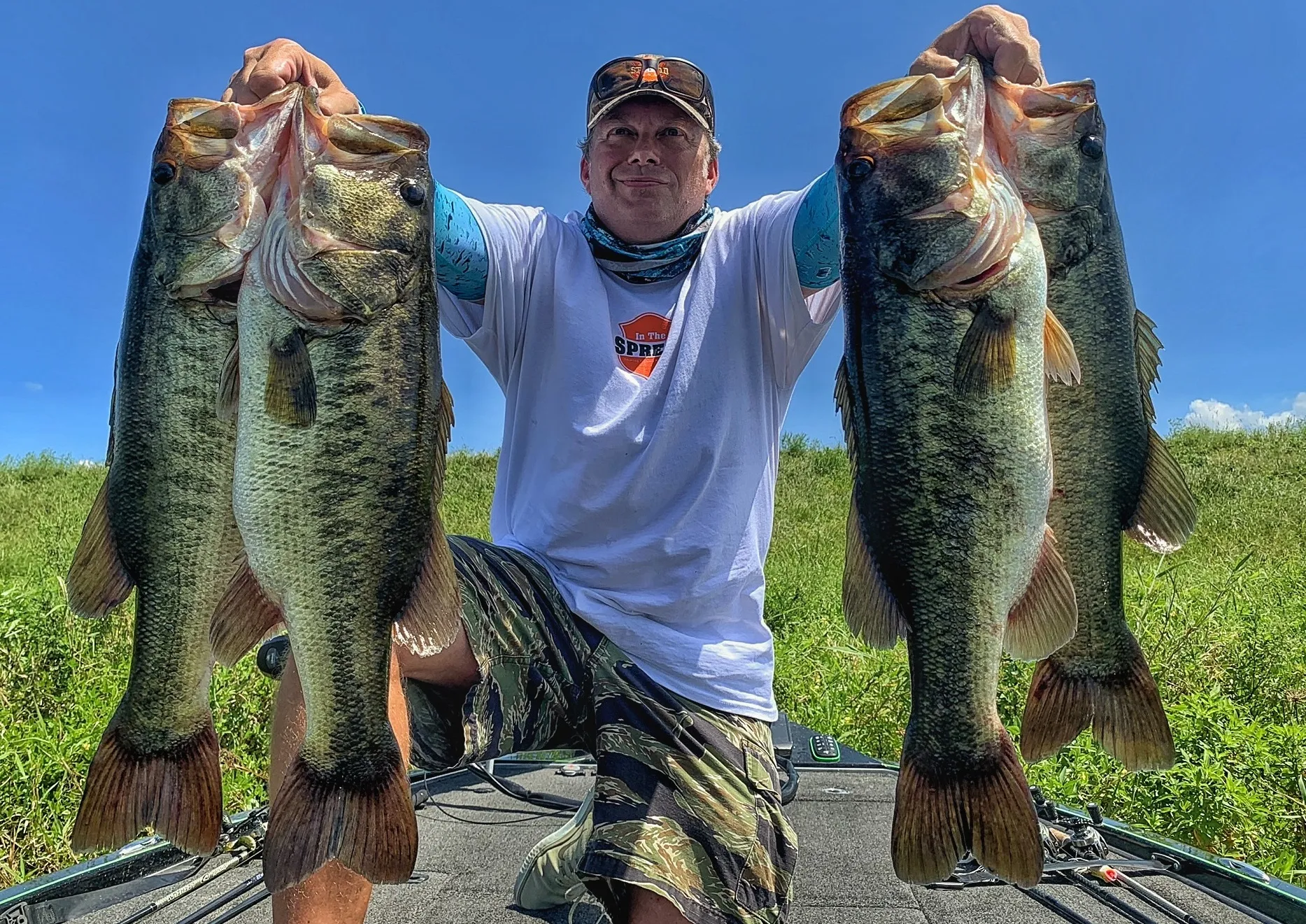 Seth Horne holds up several nice largemouth bass caught in Florida