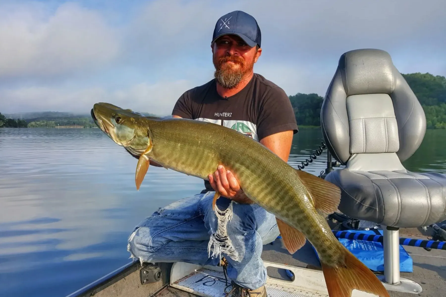 Tennessee musky fishing with Cory Allen holding a beautiful muskellunge
