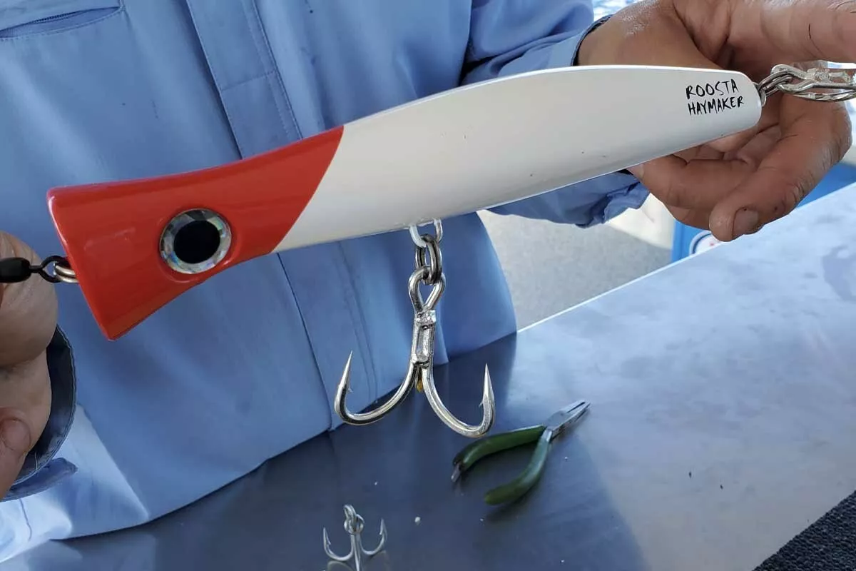 Chris Rushford holds Halco roosta popper rigged with heavy gauge treble hooks for GT fishing