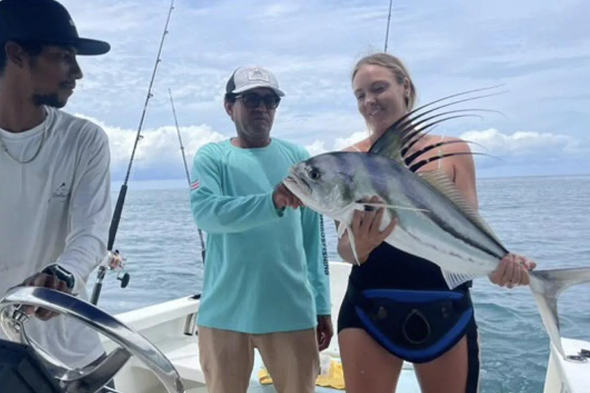 fishing guide luis salazar puts client on roosterfish in costa rica