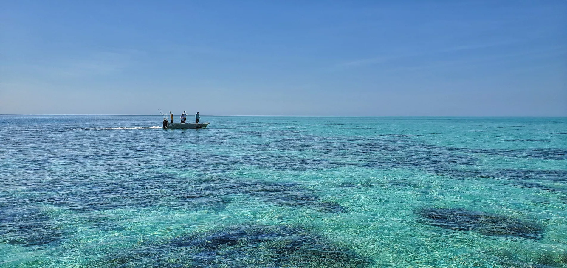 fishermen boating across the reef at rowley shoals