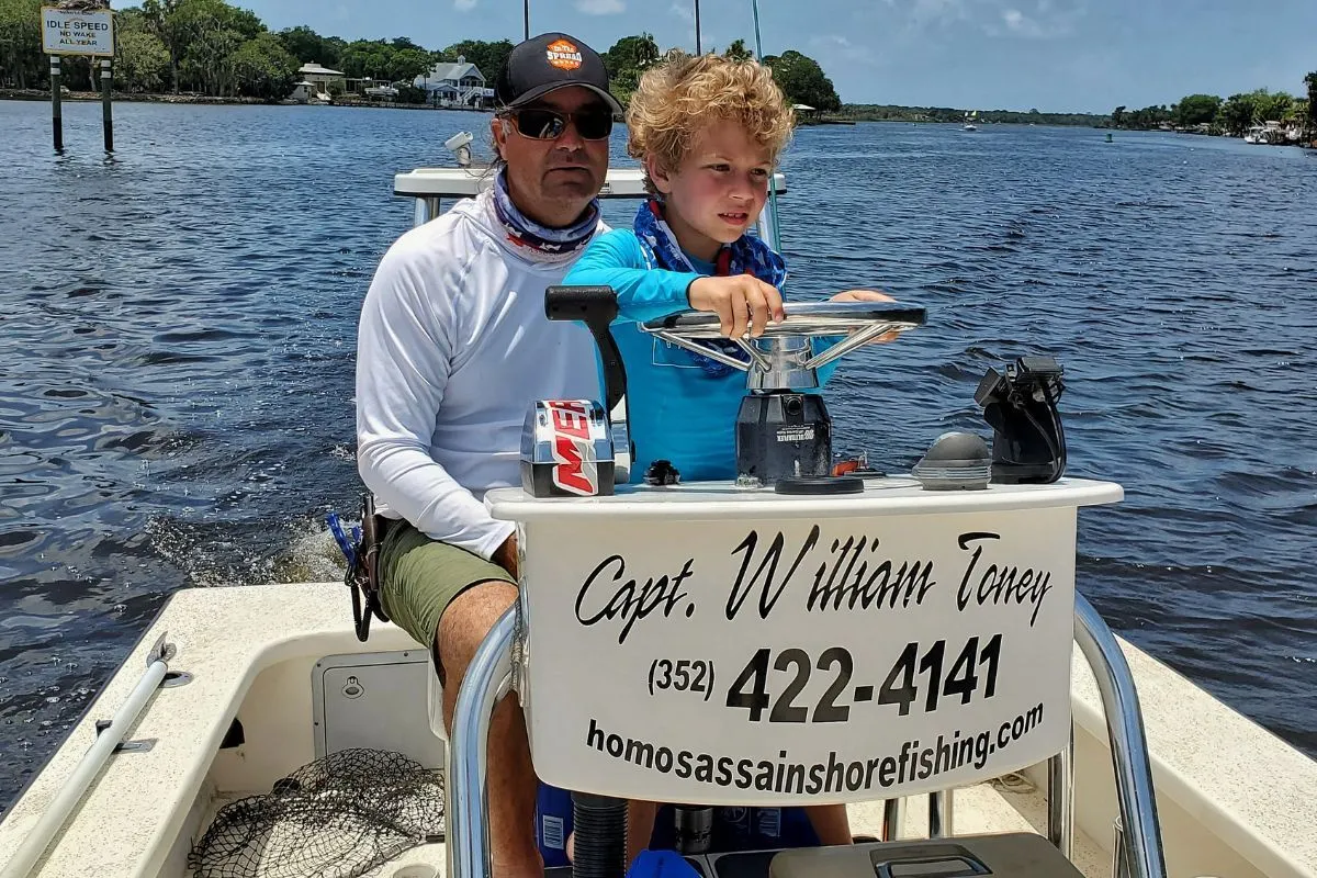 William Toney teaching child boat driving on the Homosassa River
