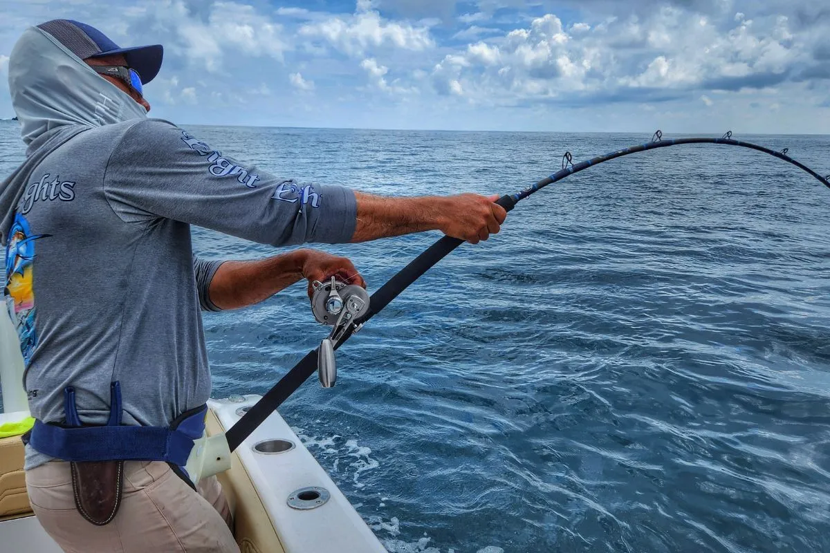 angler battling giant grouper boatside