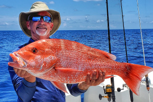 Kevin Adney holds up Red Snapper caught out at Florida middle grounds