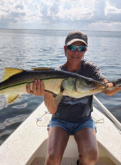 female angler holding trophy Homosassa snook caught fishing with William Toney