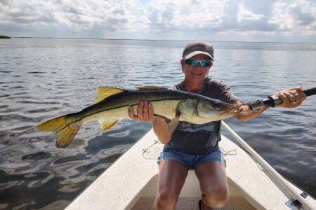 female angler holding trophy Homosassa snook caught fishing with William Toney
