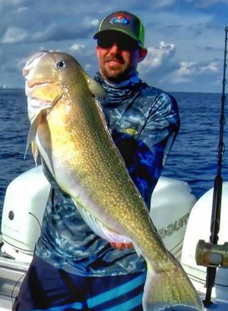 Capt. Mike Dumas holding a golden tilefish caught deep dropping off South Florida