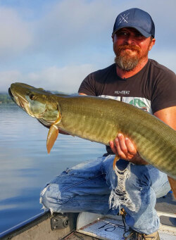 Cory Allen holding a nice musky caught trolling