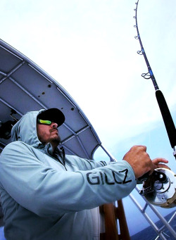 Mike Dupree reels in a wahoo while slow trolling