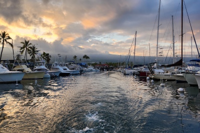 Sportfishing charter boat leaving the Honokohau marina in Kona Hawaii at sunrise for a guided fishing trip. 