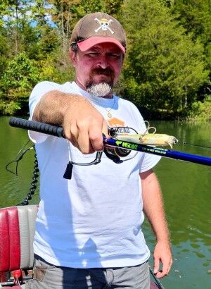 Cory Allen holding a vexan 7' 6" inshore spinning rod for musky