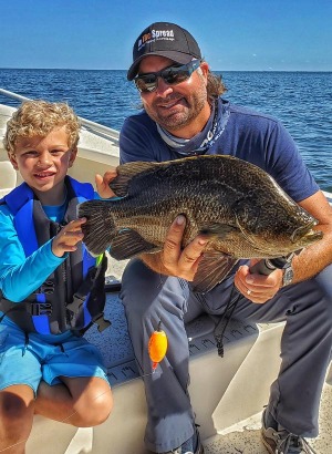 Captain William Toney holds a nice tripletail fish 