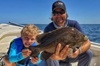 Captain William Toney holds a nice tripletail fish 