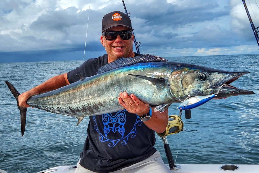 in the spread owner seth horne holding a big wahoo caught in costa rica