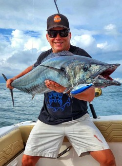 in the spread owner seth horne holding a big wahoo caught in costa rica