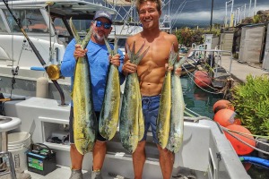Captain Shawn Rotella of Kona Hawaii holds a dolphin caught trolling