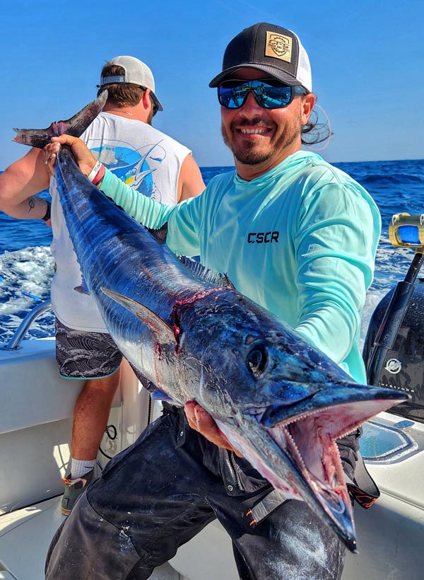 mike dupree holds a wahoo caught slow trolling with planers