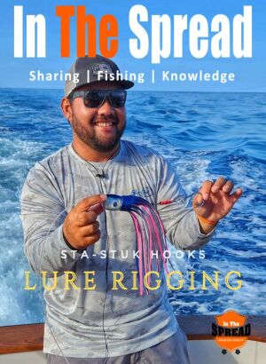 Kris Ishibashi holding a blue marlin lure rigged with Sta-Stuk hook