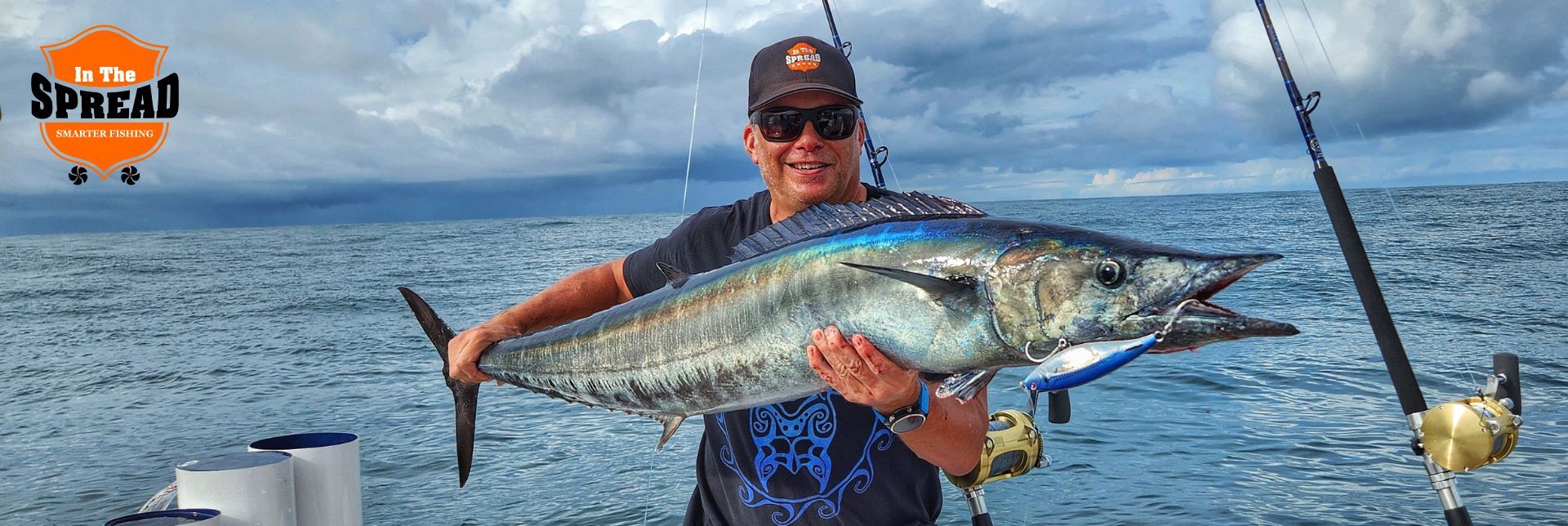 Seth Horne holding a wahoo caught casting stickbaits offshore
