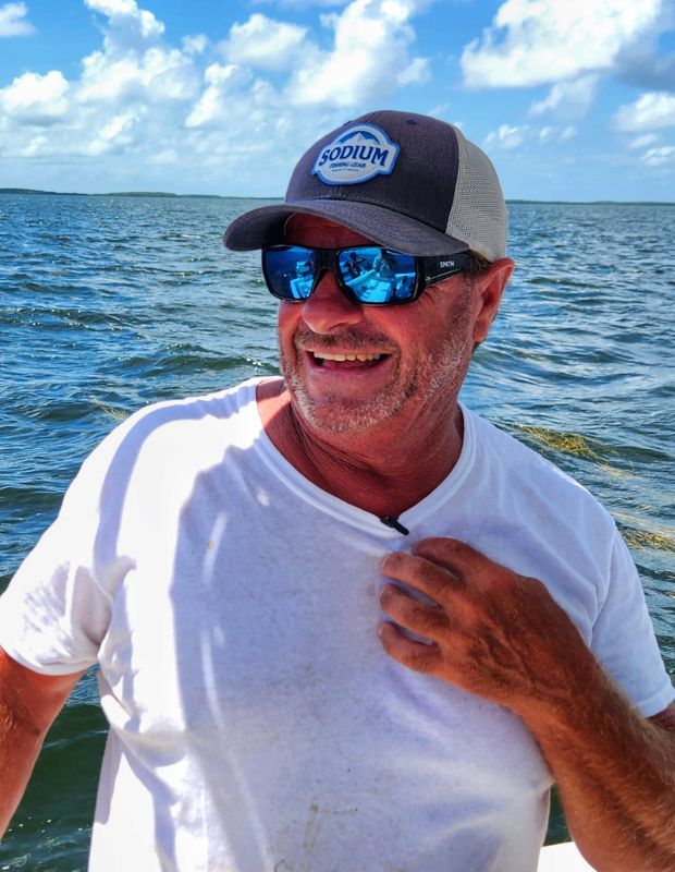 Captain Chris Wilkins smiling with offshore Gulf waters behind him off Homosassa, Florida