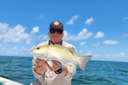 Seth Horne holding a mangrove snapper caught offshore of Homosassa, Florida