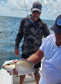 Seth Horne holding a mangrove snapper caught offshore of Homosassa, Florida