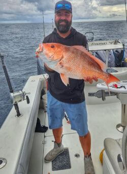 Captain Vlad Moldoveanu marking a spot on his Simrad chart plotter while reading reef structure off Alabama