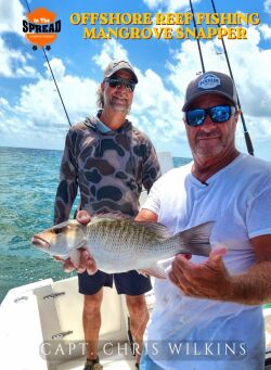 Chris Wilkins with a mangrove snapper caught on Gulf hard bottom off Homosassa as Capt. William Toney looks on