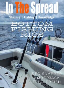 Rigged bottom fishing rod in a rocket launcher with three deep drop rod and reel setups in the rod holders behind it